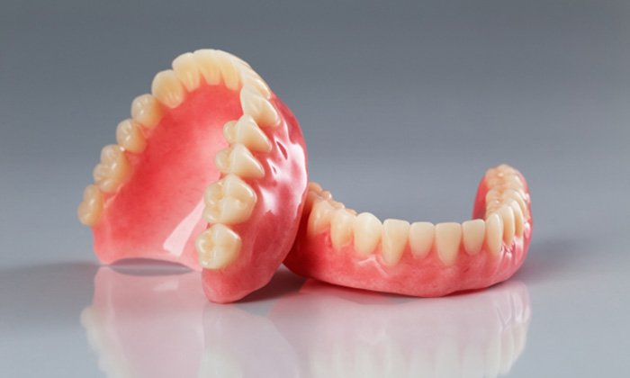 Full dentures resting on reflective surface