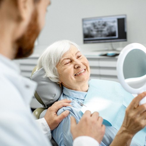 An older woman immediately enjoying her new implants
