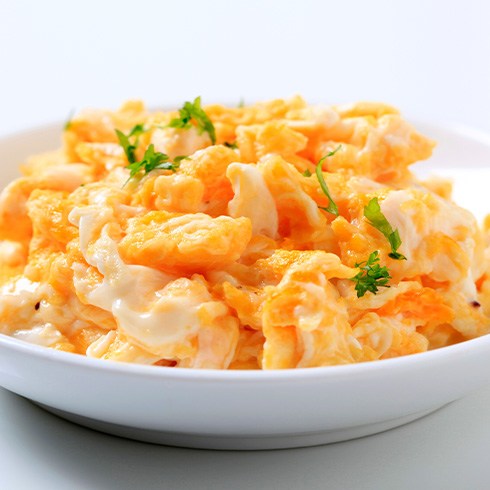 Bowl with scrambled eggs and garnish