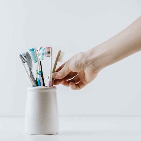 Taking toothbrush out of a toothbrush holder