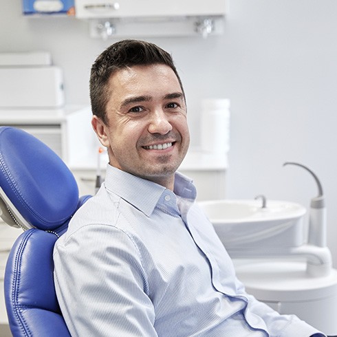 Male dental patient sitting and smiling