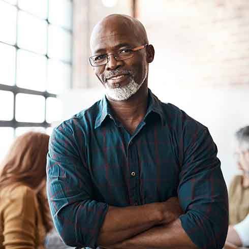 a man with glasses with his arms crossed