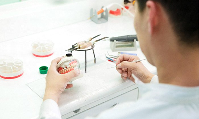 A technician working on dentures