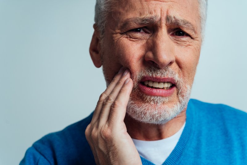 An older man suffering from denture sores