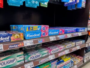 denture adhesives on shelves in a department store